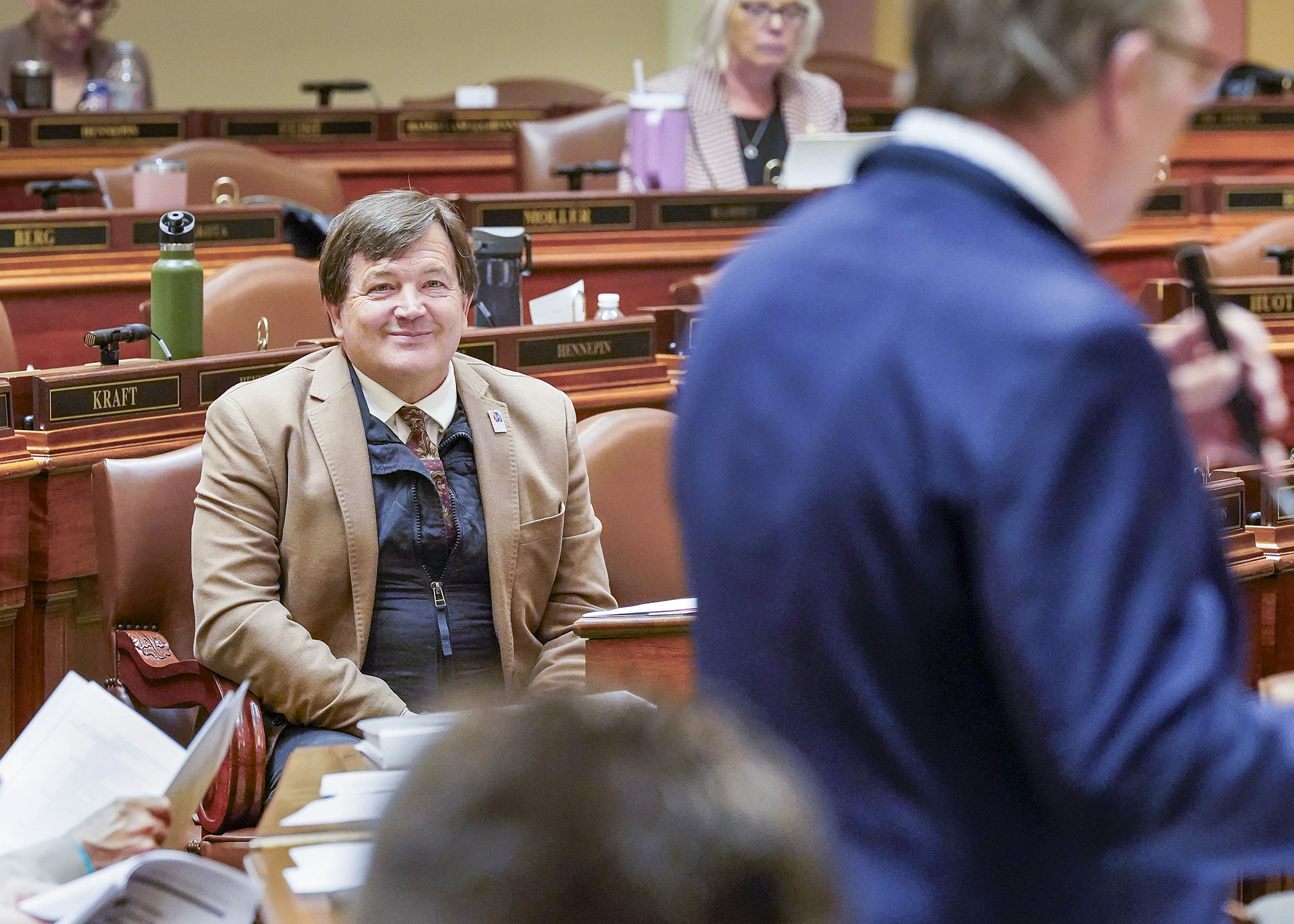 Rep. Leon Lillie, sponsor of the legacy supplemental budget bill, listens on the House Floor April 30 as Rep. Paul Torkelson unsuccessfully offers an amendment to the bill. (Photo by Andrew VonBank)